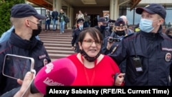 Former municipal deputy Yulia Galyamina is led out of the hotel in Novgorod on May 22. 