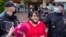 Former municipal deputy Yulia Galyamina is led out of the hotel in Novgorod on May 22. 