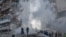 Rescuers work at a residential building partially destroyed following Russian drones and missiles strikes in Kyiv on May 14, 2026, amid the Russian invasion in Ukraine.