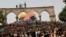 ISRAEL - Palestinians react at the compound that houses Al-Aqsa Mosque, known to Muslims as Noble Sanctuary and to Jews as Temple Mount, in Jerusalem's Old City May 21, 2021.