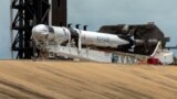 U.S. -- Crews work on the SpaceX Crew Dragon, attached to a Falcon 9 booster rocket, as it sits horizontal on Pad39A at the Kennedy Space Center in Cape Canaveral, Florida, U.S. May 26, 2020. 