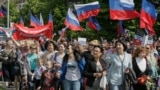 Ukraine -- Citizens carry flags during a march marking the second anniversary of the independence referendum in downtown Donetsk, Ukraine, 11 May 2016.
