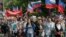 Ukraine -- Citizens carry flags during a march marking the second anniversary of the independence referendum in downtown Donetsk, Ukraine, 11 May 2016.