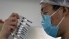 CHINA -- A worker inspects syringes of a vaccine for COVID-19 produced by Sinovac at its factory in Beijing, September 24, 2020