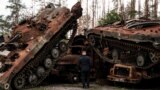 UKRAINE – A Ukrainian policeman near the destroyed Russian armored vehicles on the outskirts of the city of Lyman, which was liberated from the Russian army earlier in the day. Lyman, Donetsk region, October 5, 2022