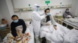 CHINA -- A doctor checks the conditions of a patient at Jinyintan Hospital, designated for critical COVID-19 patients, in Wuhan, Hubei province, February 13, 2020
