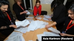 Members of an election commission count ballots at a Baku polling station after early parliamentary elections in Azerbaijan on February 9, 2020.