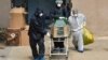 NORTH MACEDONIA -- Medical workers push carts with coffin of a victim of the novel coronavirus (COVID-19) at the University Clinic for Infectious Diseases, in Skopje, March 31, 2020