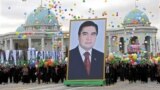 TURKMENISTAN -- People carry a picture of Turkmen President Gurbanguly Berdymukhammedov to mark Turkmenistan's Independence Day in Ashgabat on October 27, 2009. 