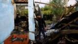 AZERBAIJAN -- Locals inspect the house hit by a rocket during the fighting over the breakaway region of Nagorno-Karabakh, in the village of Baharli, October 15, 2020