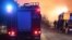 Poland -- Fire trucks can be seen as houses burn after a gas pipeline exploded in Jankow Przygodzki village, western Poland, on November 14, 2013.