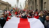 BELARUS -- Belarusian pensioners carrying a former white-red-white flag of Belarus parade through the streets during a rally to demand the resignation of authoritarian leader and new fair election, in Minsk, November 2, 2020