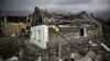 UKRAINE – Ukraіnian flag in front of a partially destroyed building in Irpin, Kyiv region, June 16, 2022